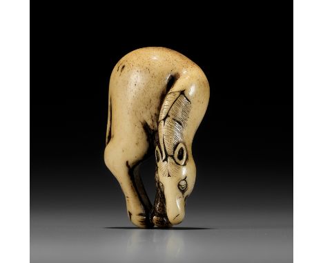 A SUPERB ANTLER NETSUKE OF A GRAZING HORSE, ATTRIBUTED TO TSUNEMASAAttributed to Tsunemasa, unsignedJapan, Kyoto, early to mi