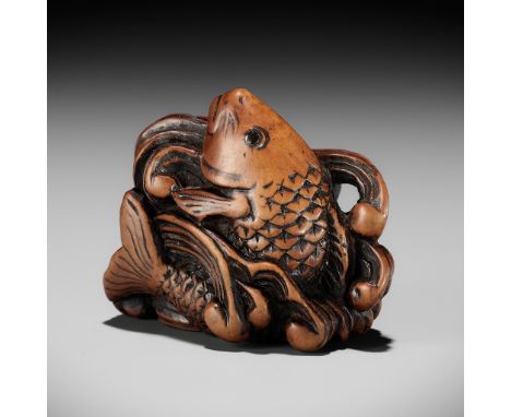 A SUPERB WOOD NETSUKE OF A LEAPING CARP AMONGST TURBULENT WAVESUnsignedJapan, late 18th to early 19th century, Edo period (16