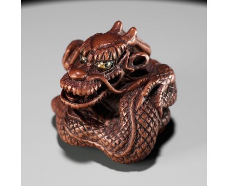 MINKO: A POWERFUL WOOD NETSUKE OF A COILED DRAGONBy Tanaka Juntoku Minko (1735-1816), signed Minko 岷江 and kakihanJapan, Tsu, 