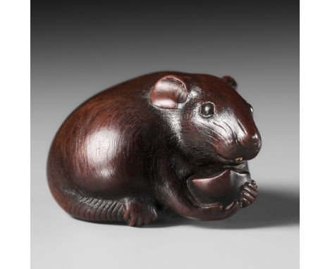 TOMOKAZU: A FINE WOOD NETSUKE OF A RAT EATING A CHESTNUTBy Kano Tomokazu, signed Tomokazu 友一Japan, Gifu, early 19th century, 