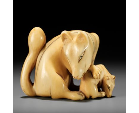 A RARE IVORY NETSUKE OF A KITSUNE (FOX) AND CUBUnsignedJapan, 18th centuryThe fox seated seated, her head turned down to the 