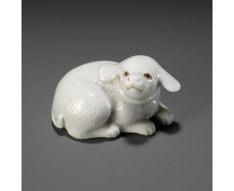 AN EXQUISITE HIRADO PORCELAIN NETSUKE OF A PUPPYUnsignedJapan, 19th centuryFinely and sensitively modeled, the recumbent dog 