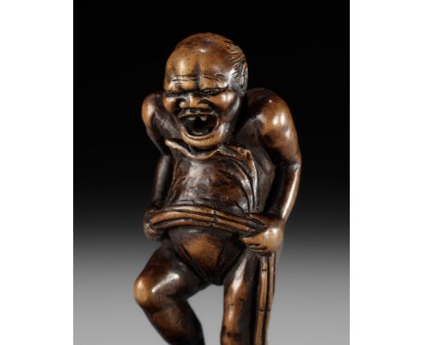 TOUN: AN AMUSING WOOD NETSUKE OF A NAKED MAN TYING HIS FUNDOSHIBy Toun, signed Toun 東雲Japan, Edo (Tokyo), late 18th century t