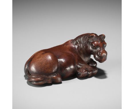 A SUPERB WOOD NETSUKE OF A RECUMBENT HORSEUnsignedJapan, late 18th to early 19th century, Edo period (1615-1868)Published: O'