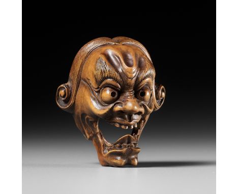 A PALE BOXWOOD KYOGEN MASK NETSUKE OF A GROTESQUE FOREIGNER, ATTRIBUTED TO KOKEISAI SANSHOAttributed to Kokeisai Sansho (1871