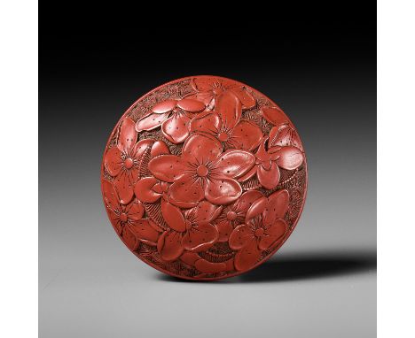 A FINE TSUISHU (CARVED RED LACQUER) MANJU NETSUKE WITH PEACH BLOSSOMSUnsignedJapan, 19th century, Edo period (1615-1868)The t