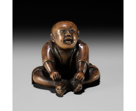 A CHARMING EDO SCHOOL WOOD NETSUKE OF A SEATED BOYUnsignedJapan, Edo (Tokyo), mid-19th century, Edo period (1615-1868)Finely 