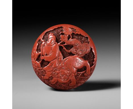 A FINE TSUISHU (CARVED RED LACQUER) MANJU NETSUKE WITH CHINESE LITERATI AND SHISHIUnsignedJapan, 18th century, Edo period (16