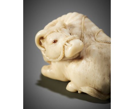 KAIGYOKUSAI MASATSUGU: A MASTERFUL AND IMPORTANT IVORY NETSUKE OF A RECUMBENT OXBy Kaigyokusai Masatsugu (1813-1892), signed 