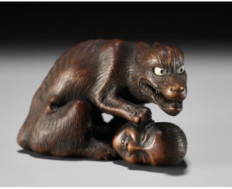 SHIGEKAZU: A FINE WOOD NETSUKE OF AN EMACIATED WOLF WITH A SEVERED HEADBy Shigekazu, signed Shigekazu 重一Japan, Tanba Province