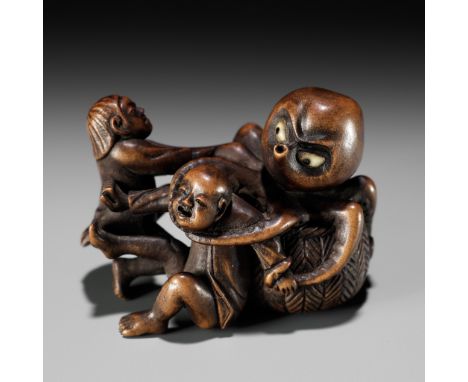 TAMEKAZU: AN AMUSING WOOD NETSUKE OF TWO FISHERMEN FIGHTING AN OCTOPUSBy Tamekazu, signed Tamekazu 為一Japan, 19th century, Edo