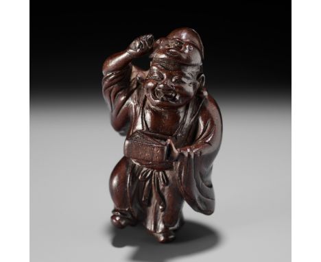 A FINE WOOD NETSUKE OF HOTEI AT SETSUBUNUnsignedJapan, Edo (Tokyo), mid-19th century, Edo period (1615-1868)Humorously carved
