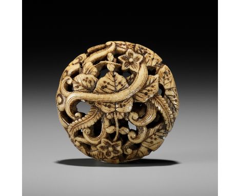 AN ANTLER RYUSA MANJU NETSUKE WITH FLORAL DESIGNUnsignedJapan, Tokyo, Asakusa district, second half of the 19th centuryFinely
