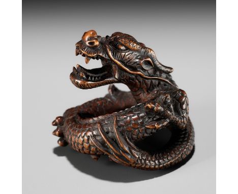 MASANAO SHINZAN: A FINE INLAID BOXWOOD NETSUKE OF A COILED DRAGONBy Masanao Shinzan (1904-1982), signed Masanao Shinzan 正直辰山J