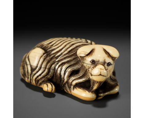 A RARE IVORY NETSUKE OF A JAKONEKO (MUSK CAT)UnsignedJapan, 18th century, Edo period (1615-1868)A finely carved, charming dep