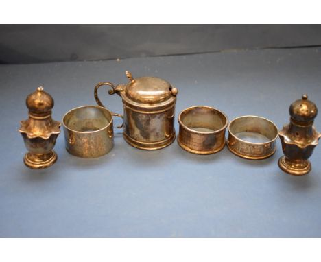 A pair of silver pepperettes, by Atkins Bros, Sheffield 1902; together with a silver drum mustard; and three silver napkin ri
