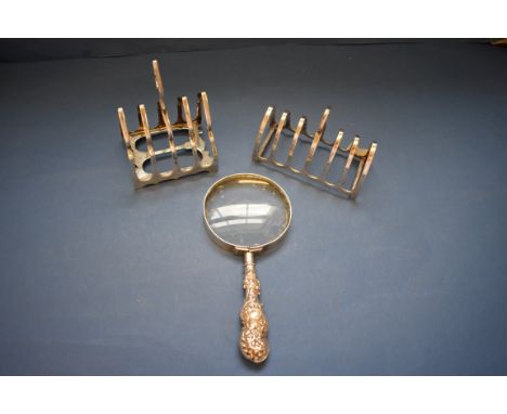 A silver six section toast rack, by Barker Bros, Chester 1911; together with a similar four section example, by James Deakin 