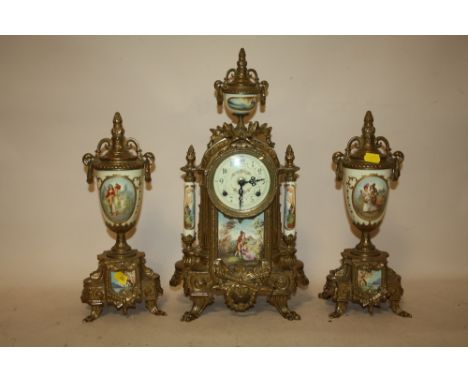 A MODERN BRASS AND CERAMIC CLOCK GARNITURE WITH FIGURATIVE DETAIL