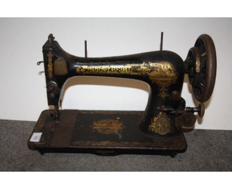 AN UNCASED VINTAGE SINGER SEWING MACHINE