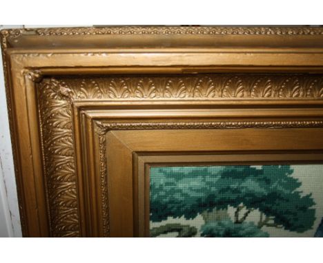 A LARGE ANTIQUE GILT FRAME, with Acanthus moulded detail throughout, with an inset tapestry of a peacock, frame dimensions 96