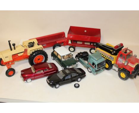 A ERTL 2557 AGRIKING MODEL TRACTOR, A REMCO BIG RIG TOWING TRUCK, TRAILERS AND FOUR OTHER DIECAST VEHICLES TO INCLUDE BURAGO 