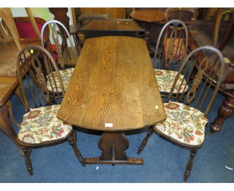 AN OAK DECORATIVE TABLE WITH FOUR ERCOL STYLE CHAIRS
