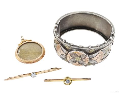 Victorian silver hinged bangle, with applied gold foliate decoration, two early 20th century 9ct gold stone set brooches incl