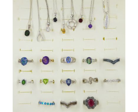 Thirteen silver stone set rings including amethyst, diamond, ruby, peridot and opal and nine silver stone set pendant necklac