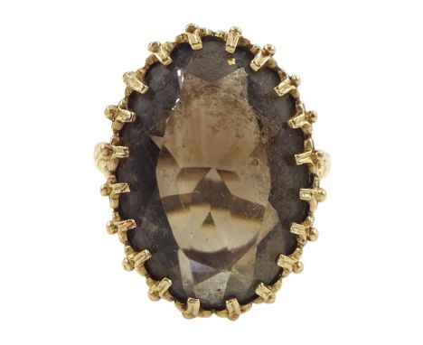 9ct gold single stone oval cut smokey quartz ring, London 1978Condition Report:Approx 7.55gm, size R, overall head = 24mm x 1