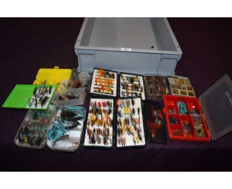 A selection of fishing flies (mostly salmon) in an assortment of boxes