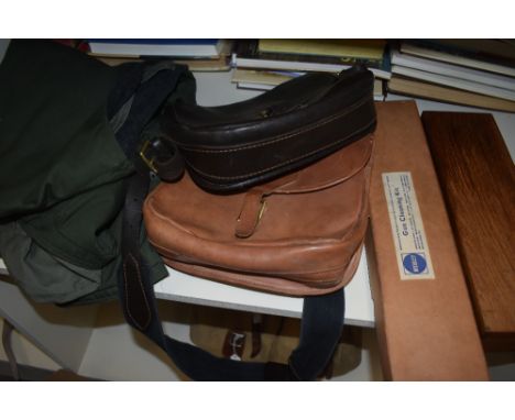 A collection of two leather cartridge bags five cartridge belts and three gunslips along with a fishing waistcoat by wychwood