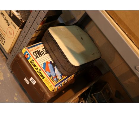 Suitcase of dolls, a golly and a petite typewriter 