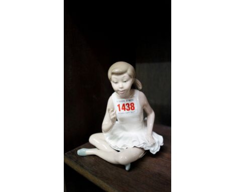 A Nao figure of a seated ballerina.