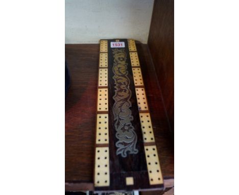 A Victorian rosewood, brass and ivory cribbage board, 31.5cm long. 