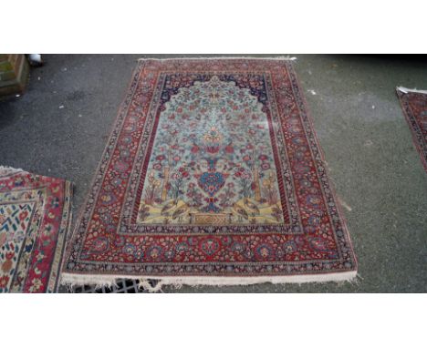 A pair of Persian Isfahan prayer rugs, having light blue floral field with large vases, trees, shrubs and birds, 216 x 140cm.