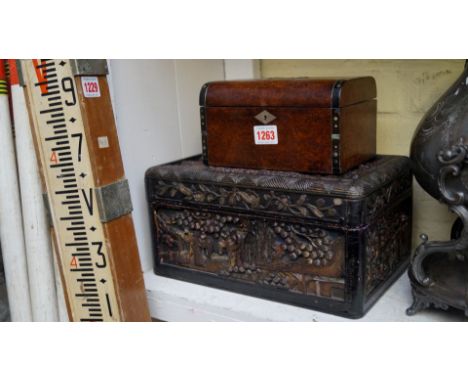 A burr walnut and inlaid tea caddy, 19cm wide; together with an oriental carved wood casket, 31cm wide. 