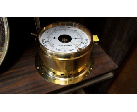 A brass bulkhead style aneroid barometer. 