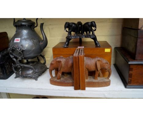 A walnut rectangular casket, 30.5cm wide; together with a pair of carved elephant bookends; and another ebony elephant tripod