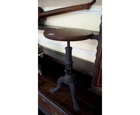 An unusual 19th century cast iron adjustable tripod stand or stool, with later mahogany circular top, 30.5cm wide. 