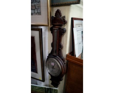 An antique carved mahogany aneroid wheel barometer, the silvered dial inscribed 'Benetfink & Co, Cheapside, London'.