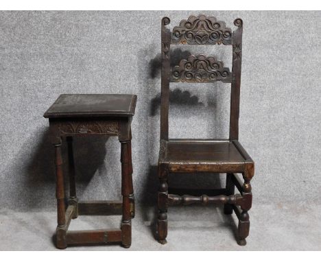 An antique style country oak carved armchair together with a similar side table. H.108cm 