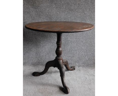 A Georgian mahogany circular tilt top occasional table on well carved tripod cabriole base terminating in ball and claw feet.