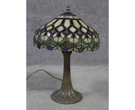 A Tiffany style iridescent stained glass table lamp. Shade has a repeating geometric design resembling stylised foliate and f