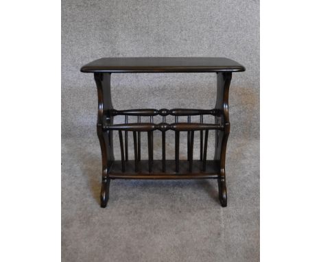 A vintage Ercol elm occasional table fitted with magazine rack to base. H.50 x 56cm 