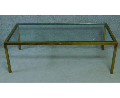 A vintage glass coffee table on brass frame. H.51 W.153 D.77cm 