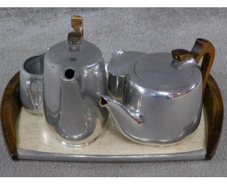 A vintage Picquot ware tea set and tray, metal salt and pepper shakers and sugar bowl. All the piquot ware pieces have wooden