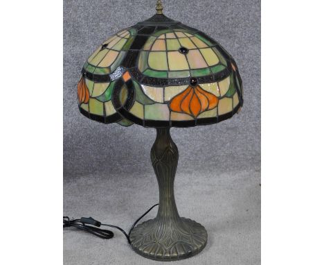 A Tiffany style iridescent stained glass table lamp. Shade has an Art Nouveau floral design with moulded stylised foliate des