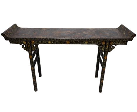 A late 19th century Chinese black lacquer chinoiserie decorated altar table, the rectangular top with up turned ends, on turn