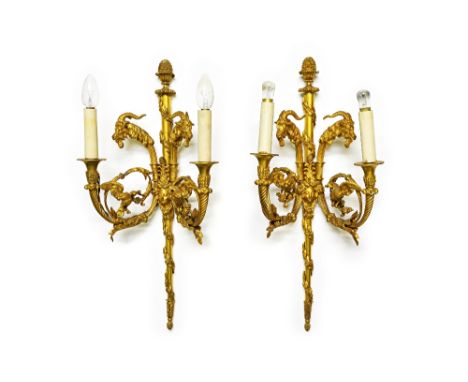 A pair of French ormolu twin light wall appliques, 20th century, each with central tapering backplate with foliate finial and