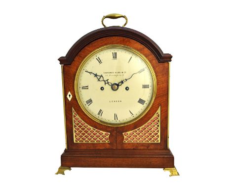 A mahogany cased bracket clock by Camerer, Kuss & Co, London, with arch pad top and painted tin dial, on a plinth base and br